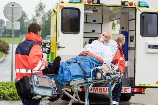 man being placed in an ambulance after a car accident with an underinsured driver