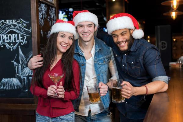 three friends drinking at a Christmas party before a drunk driving car accident